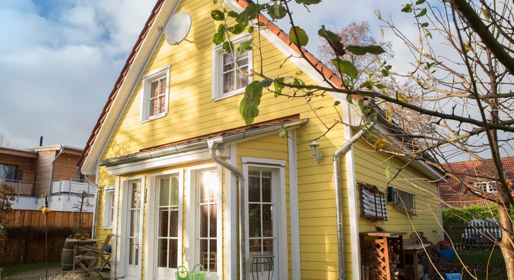 Ein gelbes Schwedenhaus mit einem Glaserker